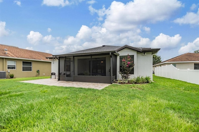 12251 Duckett Ct, Spring Hill, FL 34610 - back of property with a sunroom, a patio area, and stucco siding