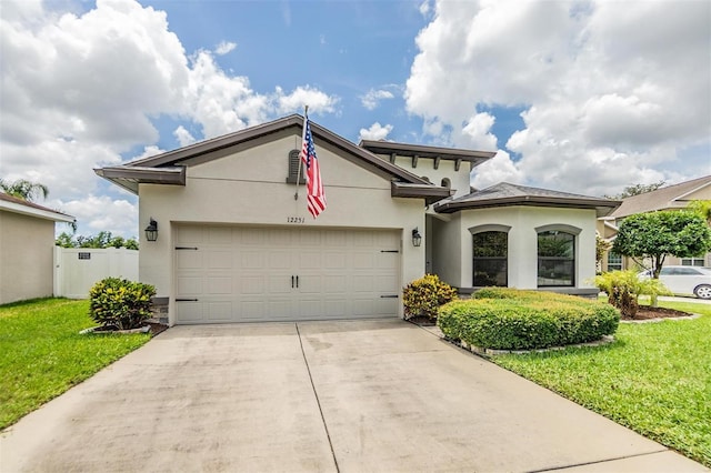 12251 Duckett Ct, Spring Hill, FL 34610 - view of front of property featuring stucco siding, a garage, concrete driveway, and a front yard