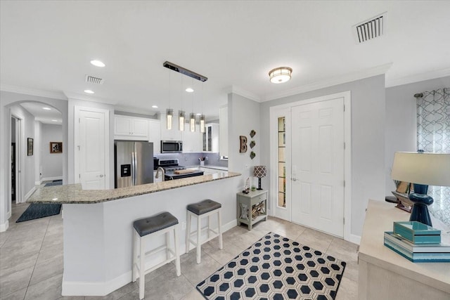 10450 Highland Park Pl, Palmetto, FL 34221 - kitchen with appliances with stainless steel finishes, arched walkways, crown molding, a peninsula, and light stone counters