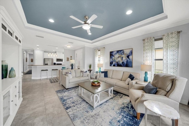 10450 Highland Park Pl, Palmetto, FL 34221 - living room with a tray ceiling, ceiling fan, crown molding, recessed lighting, and light tile patterned floors