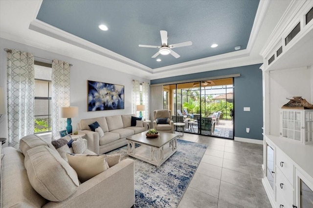 10450 Highland Park Pl, Palmetto, FL 34221 - living area with a raised ceiling, ornamental molding, ceiling fan, light tile patterned floors, and recessed lighting