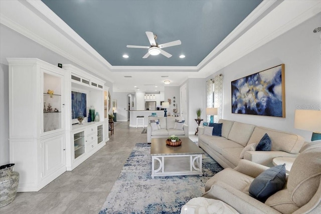 10450 Highland Park Pl, Palmetto, FL 34221 - living room with a raised ceiling, ceiling fan, ornamental molding, and recessed lighting