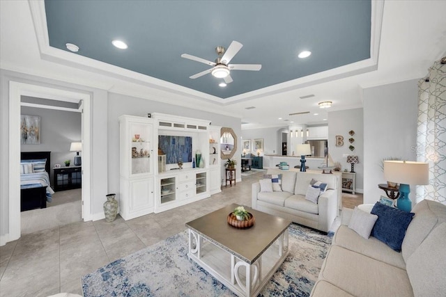 10450 Highland Park Pl, Palmetto, FL 34221 - living room with a tray ceiling, a ceiling fan, ornamental molding, recessed lighting, and light tile patterned floors
