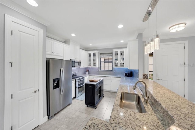 10450 Highland Park Pl, Palmetto, FL 34221 - kitchen with appliances with stainless steel finishes, ornamental molding, white cabinetry, glass insert cabinets, and recessed lighting