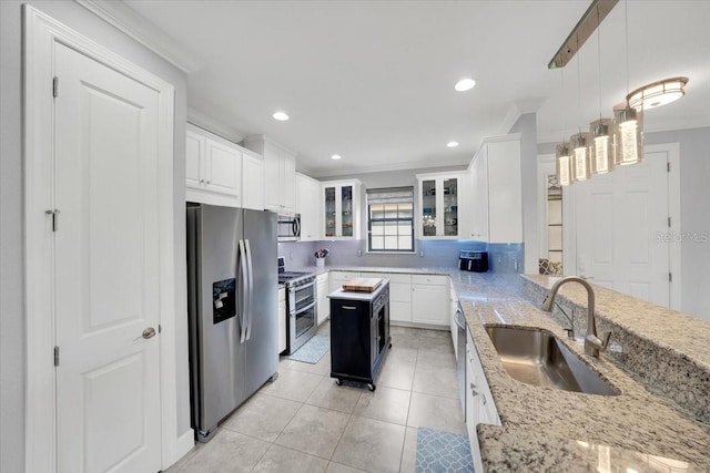 10450 Highland Park Pl, Palmetto, FL 34221 - kitchen with appliances with stainless steel finishes, crown molding, glass insert cabinets, white cabinets, and light stone countertops