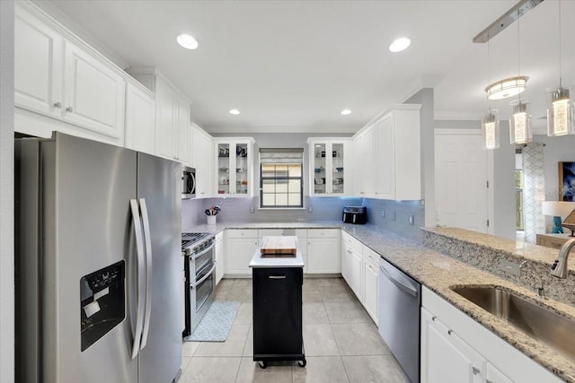 10450 Highland Park Pl, Palmetto, FL 34221 - kitchen featuring stainless steel appliances, white cabinetry, light tile patterned floors, backsplash, and crown molding