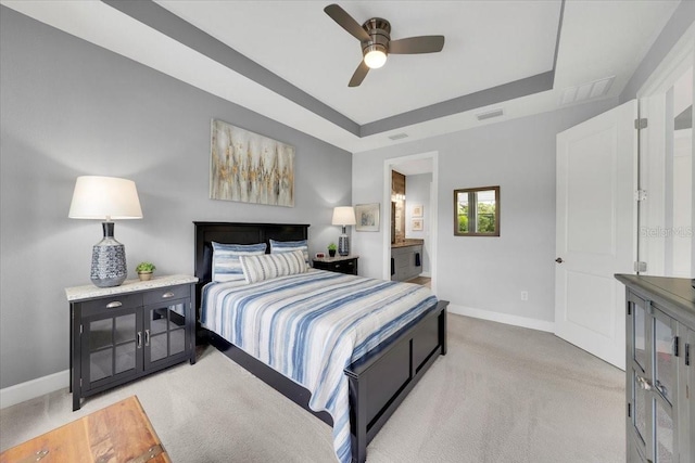 10450 Highland Park Pl, Palmetto, FL 34221 - bedroom with light colored carpet, a tray ceiling, a ceiling fan, and ensuite bath