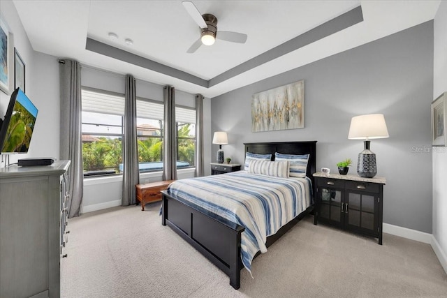 10450 Highland Park Pl, Palmetto, FL 34221 - bedroom with light carpet, a raised ceiling, and a ceiling fan