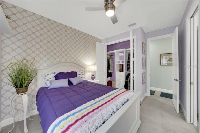 10450 Highland Park Pl, Palmetto, FL 34221 - bedroom featuring wallpapered walls, light colored carpet, a closet, a ceiling fan, and a walk in closet
