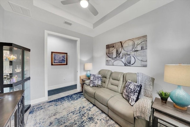 10450 Highland Park Pl, Palmetto, FL 34221 - living room featuring a ceiling fan, a raised ceiling, and tile patterned flooring