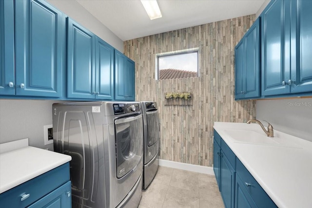 10450 Highland Park Pl, Palmetto, FL 34221 - laundry room with separate washer and dryer, cabinet space, wooden walls, and light tile patterned floors