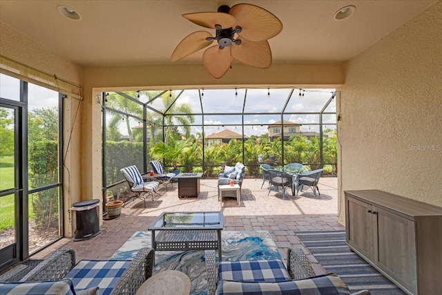 10450 Highland Park Pl, Palmetto, FL 34221 - sunroom featuring an outdoor living space with a fire pit and a ceiling fan