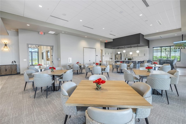10450 Highland Park Pl, Palmetto, FL 34221 - dining room with light colored carpet, a high ceiling, and a chandelier