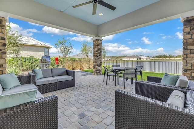 10450 Highland Park Pl, Palmetto, FL 34221 - fenced backyard with an outdoor living space, outdoor dining area, ceiling fan, and a patio area