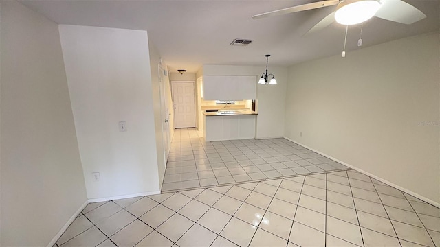 4003 Oak Limb Ct, Tampa, FL 33614 - unfurnished living room with light tile patterned flooring, ceiling fan, and a chandelier
