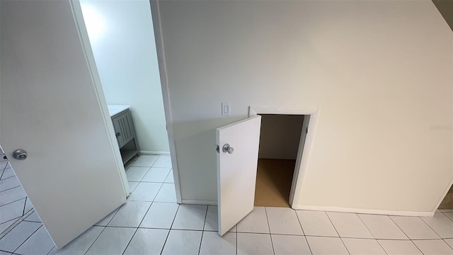 4003 Oak Limb Ct, Tampa, FL 33614 - hallway with light tile patterned flooring and baseboards