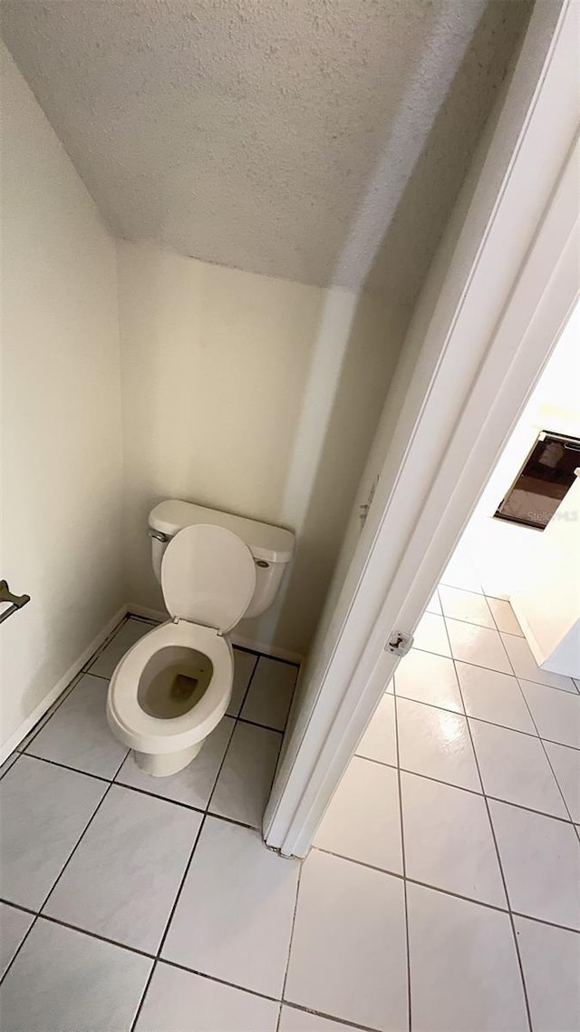 4003 Oak Limb Ct, Tampa, FL 33614 - bathroom featuring a textured ceiling and tile patterned flooring
