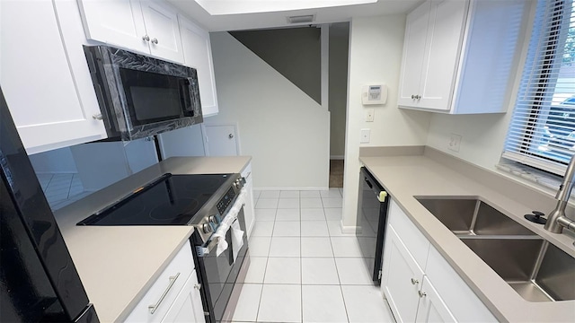 4003 Oak Limb Ct, Tampa, FL 33614 - kitchen with black appliances, white cabinets, and light countertops