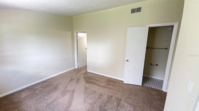 4003 Oak Limb Ct, Tampa, FL 33614 - unfurnished bedroom featuring carpet flooring and a textured ceiling