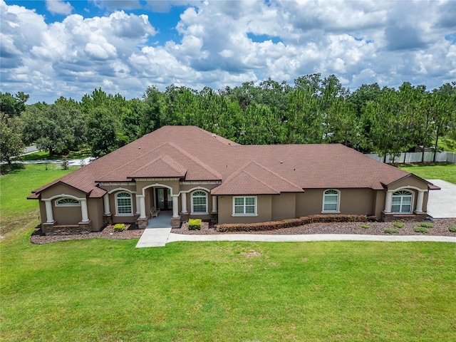 13102 Done Groven Dr, Dover, FL 33527 - mediterranean / spanish-style home featuring stucco siding, a front yard, and roof with shingles