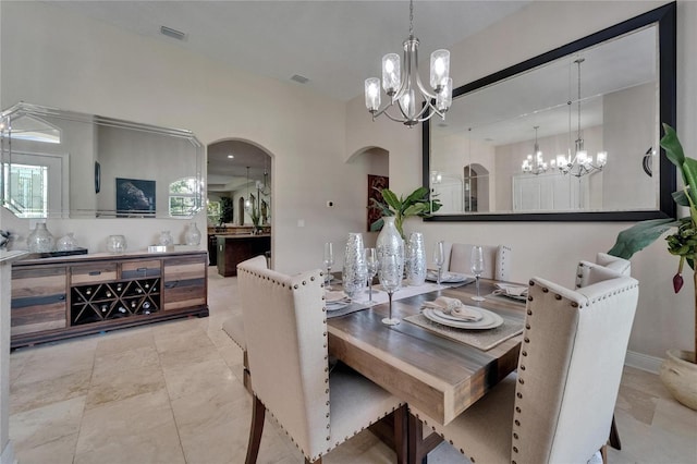 13102 Done Groven Dr, Dover, FL 33527 - dining space featuring arched walkways and a chandelier