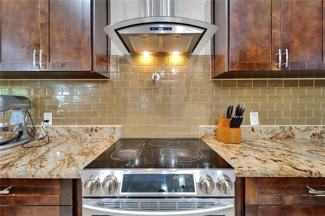 13102 Done Groven Dr, Dover, FL 33527 - kitchen featuring stainless steel electric range oven, premium range hood, decorative backsplash, light stone counters, and dark brown cabinets