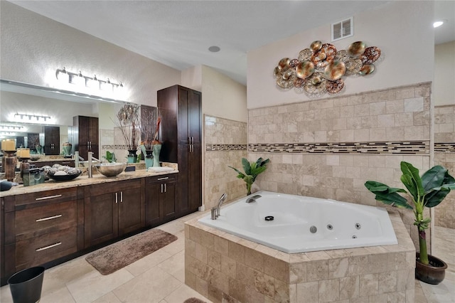13102 Done Groven Dr, Dover, FL 33527 - full bath with vanity, a whirlpool tub, tile patterned floors, and tile walls