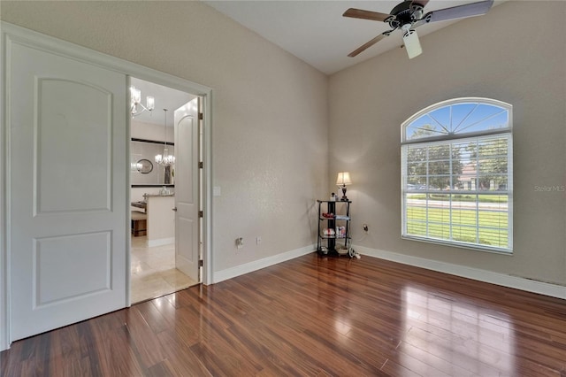 13102 Done Groven Dr, Dover, FL 33527 - empty room with a chandelier, wood finished floors, and a ceiling fan