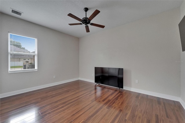 13102 Done Groven Dr, Dover, FL 33527 - unfurnished living room featuring ceiling fan, wood finished floors, and a textured ceiling