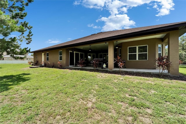 13102 Done Groven Dr, Dover, FL 33527 - back of house featuring ceiling fan, stucco siding, and a patio area