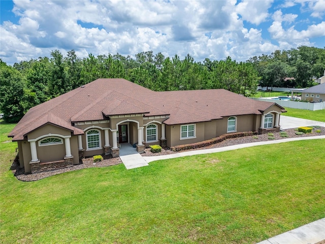 13102 Done Groven Dr, Dover, FL 33527 - view of front of house featuring stucco siding, a front lawn, and roof with shingles