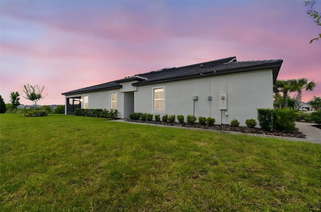 10282 Echo Dock Loop, San Antonio, FL 33576 - view of home's exterior featuring a lawn and stucco siding