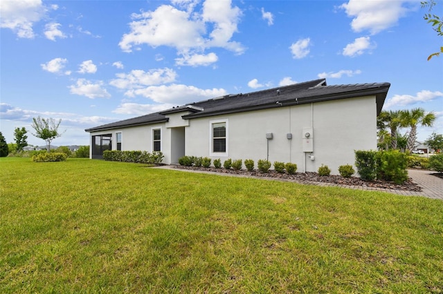 10282 Echo Dock Loop, San Antonio, FL 33576 - back of house with stucco siding and a yard