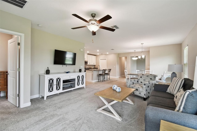 10282 Echo Dock Loop, San Antonio, FL 33576 - living room with light carpet, a ceiling fan, and a chandelier