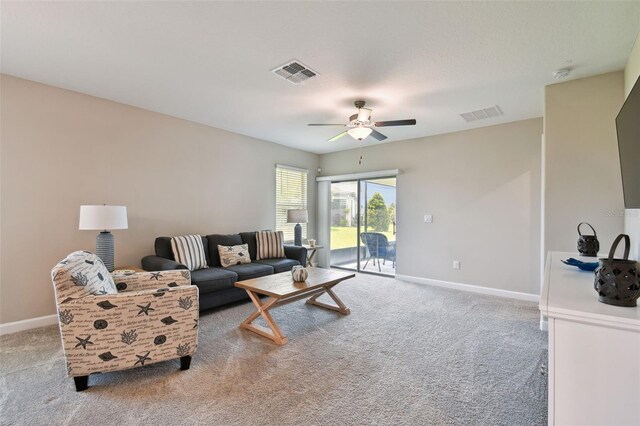10282 Echo Dock Loop, San Antonio, FL 33576 - carpeted living room with ceiling fan and baseboards