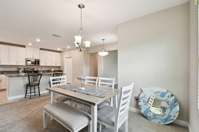 10282 Echo Dock Loop, San Antonio, FL 33576 - dining area featuring light carpet, recessed lighting, and a chandelier