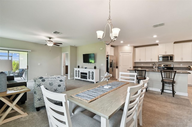 10282 Echo Dock Loop, San Antonio, FL 33576 - dining space featuring a chandelier, recessed lighting, a ceiling fan, and light colored carpet