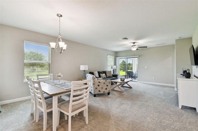 10282 Echo Dock Loop, San Antonio, FL 33576 - dining space featuring light colored carpet, a ceiling fan, and a chandelier