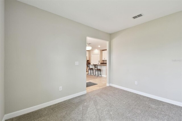 10282 Echo Dock Loop, San Antonio, FL 33576 - spare room featuring light carpet and baseboards