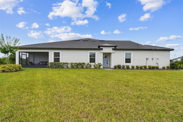10282 Echo Dock Loop, San Antonio, FL 33576 - rear view of house featuring stucco siding, a lawn, and a sunroom