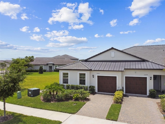 10282 Echo Dock Loop, San Antonio, FL 33576 - view of front of property with stucco siding, an attached garage, a front yard, and decorative driveway