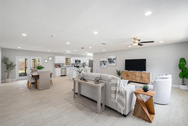 2905 Forest Cir, Seffner, FL 33584 - living area with recessed lighting, french doors, light wood-type flooring, and a ceiling fan