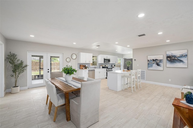 2905 Forest Cir, Seffner, FL 33584 - dining room featuring light wood finished floors, recessed lighting, and french doors