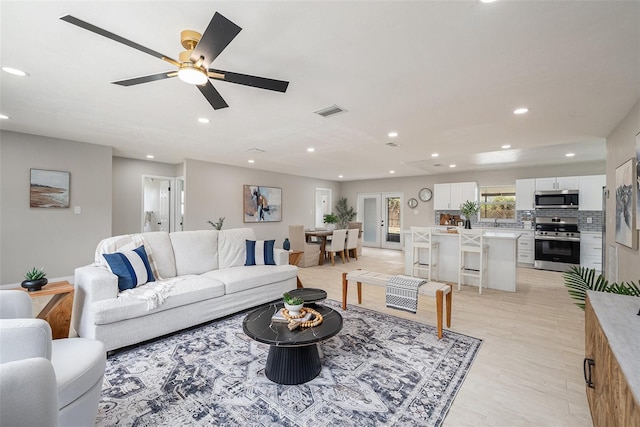 2905 Forest Cir, Seffner, FL 33584 - living room with recessed lighting, light wood finished floors, and a ceiling fan