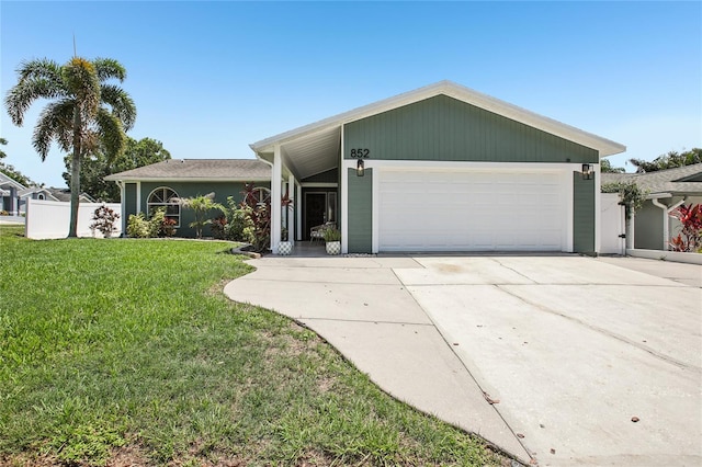 852 Crystal Dr, Palm Harbor, FL 34683 - view of front facade with an attached garage, driveway, and a front yard