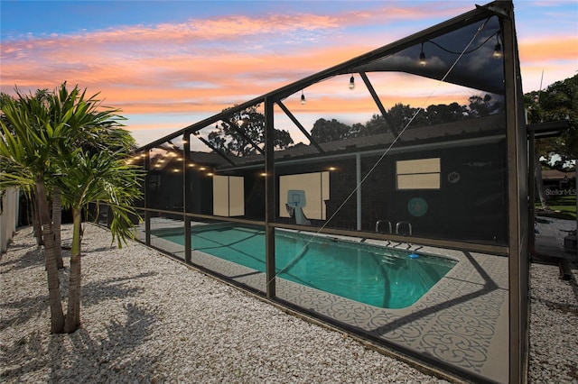 852 Crystal Dr, Palm Harbor, FL 34683 - outdoor pool featuring glass enclosure and a patio