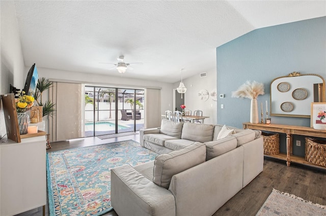 852 Crystal Dr, Palm Harbor, FL 34683 - living room with ceiling fan, wood finished floors, lofted ceiling, and a textured ceiling