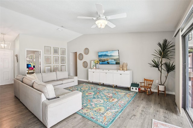 852 Crystal Dr, Palm Harbor, FL 34683 - living room featuring light wood-style floors, lofted ceiling, and ceiling fan