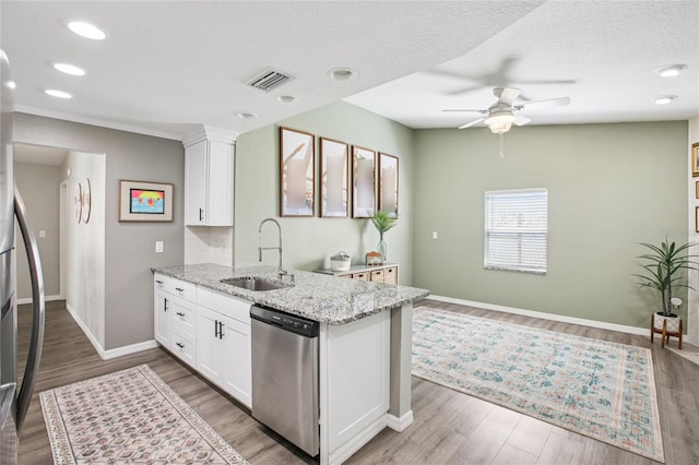 852 Crystal Dr, Palm Harbor, FL 34683 - kitchen with appliances with stainless steel finishes, a ceiling fan, white cabinetry, light stone counters, and recessed lighting