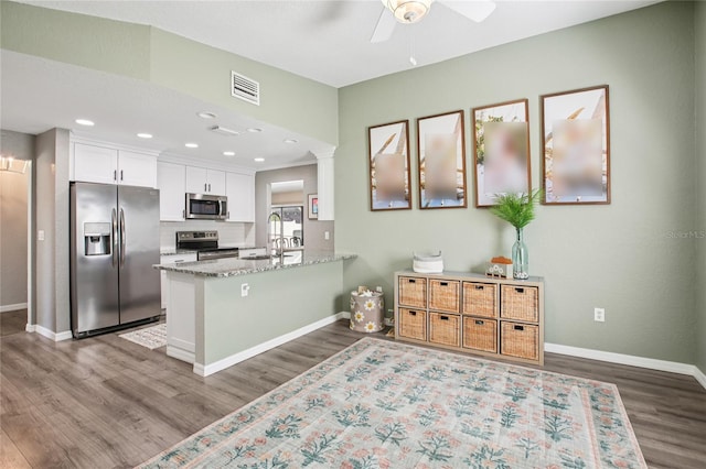 852 Crystal Dr, Palm Harbor, FL 34683 - kitchen featuring stainless steel appliances, ceiling fan, dark wood-type flooring, white cabinets, and recessed lighting
